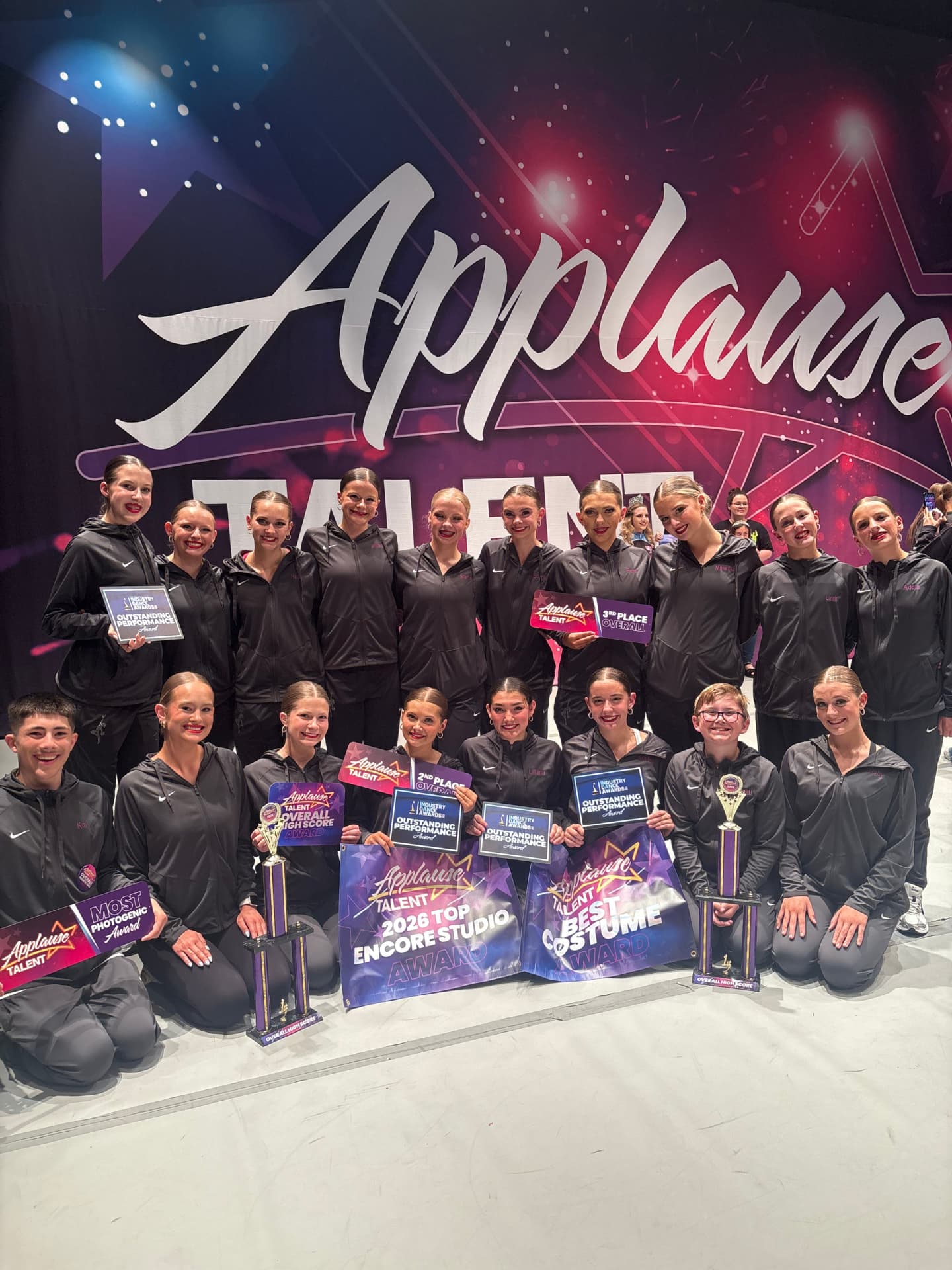 Next Level competition team with Applause Talent awards and banners